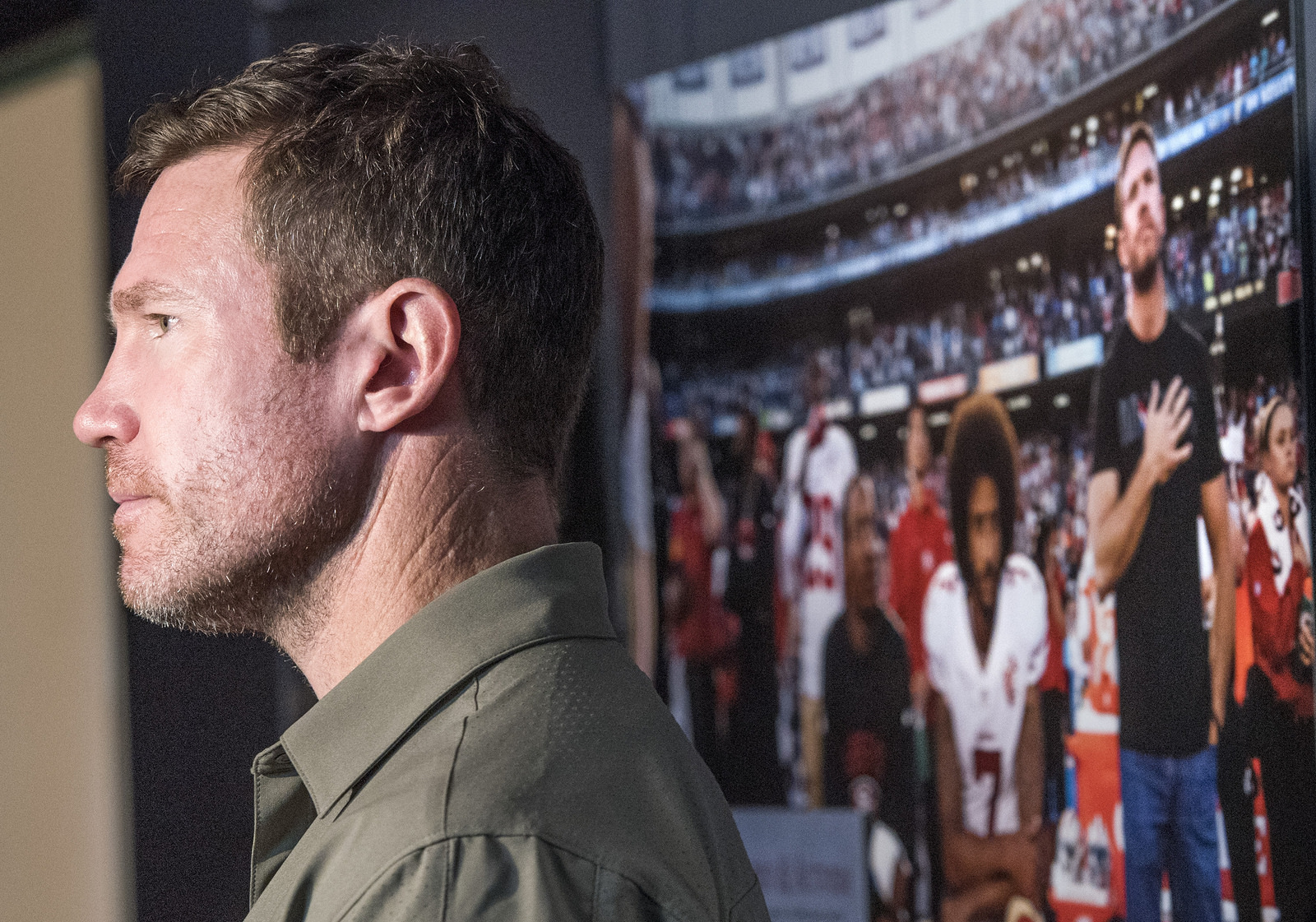 Nate Boyer stands in front of a picture of himself with Colin Kaepernick